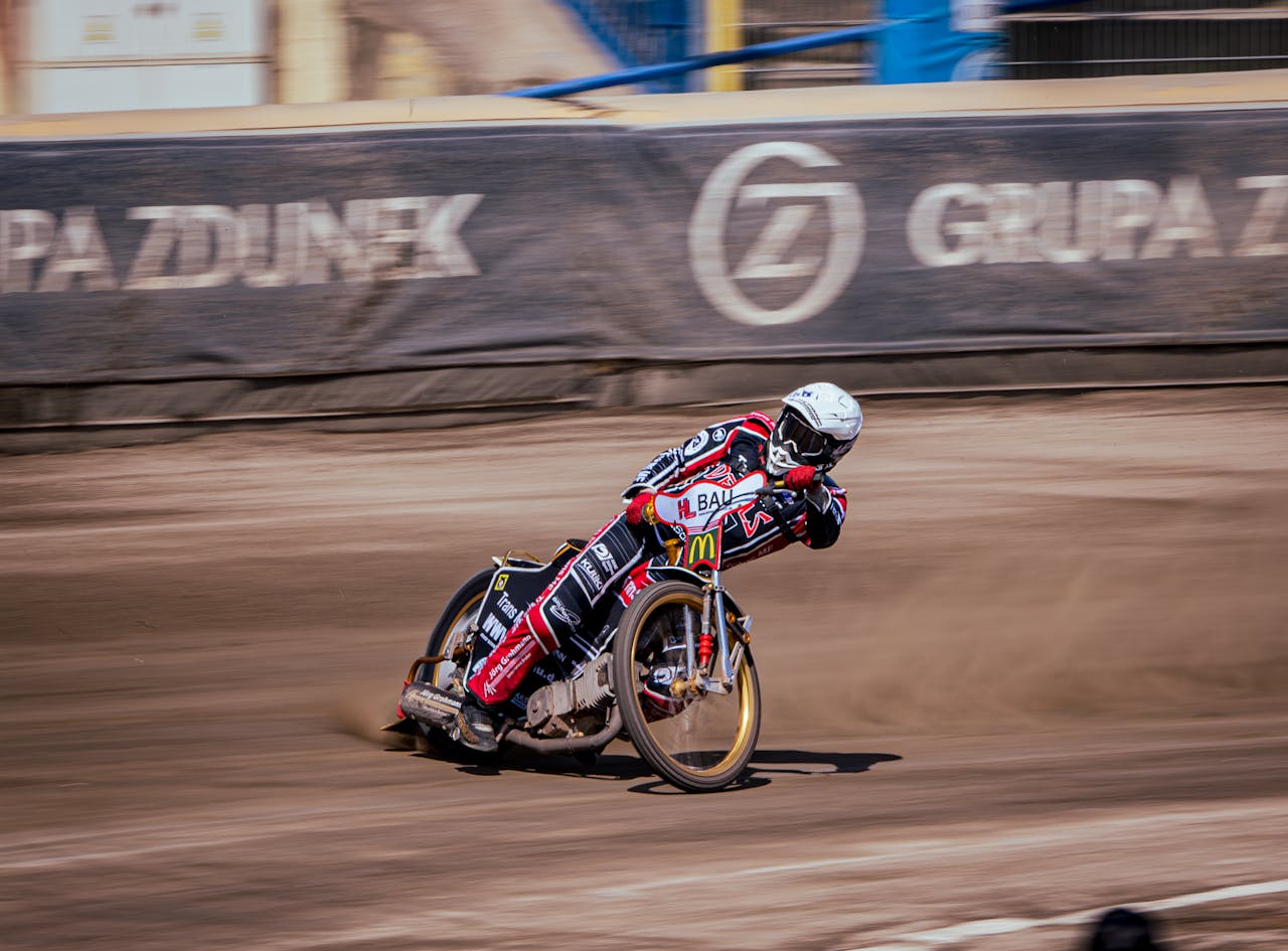 A man riding a motorcycle on a dirt track