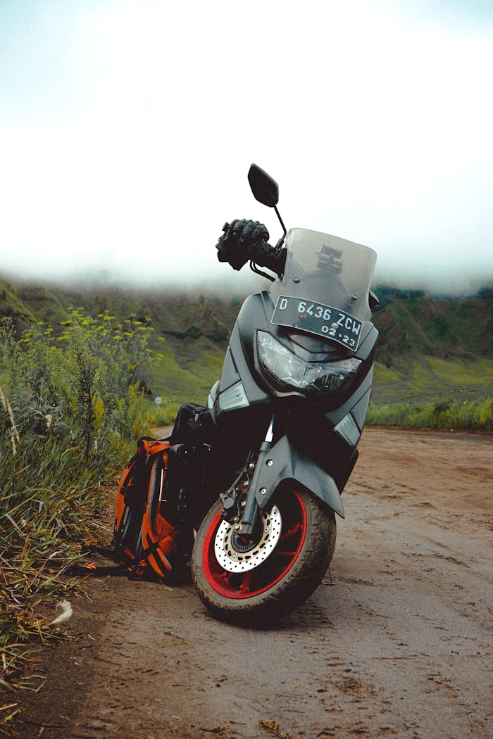 Modern motorcycle on rural road in green valley